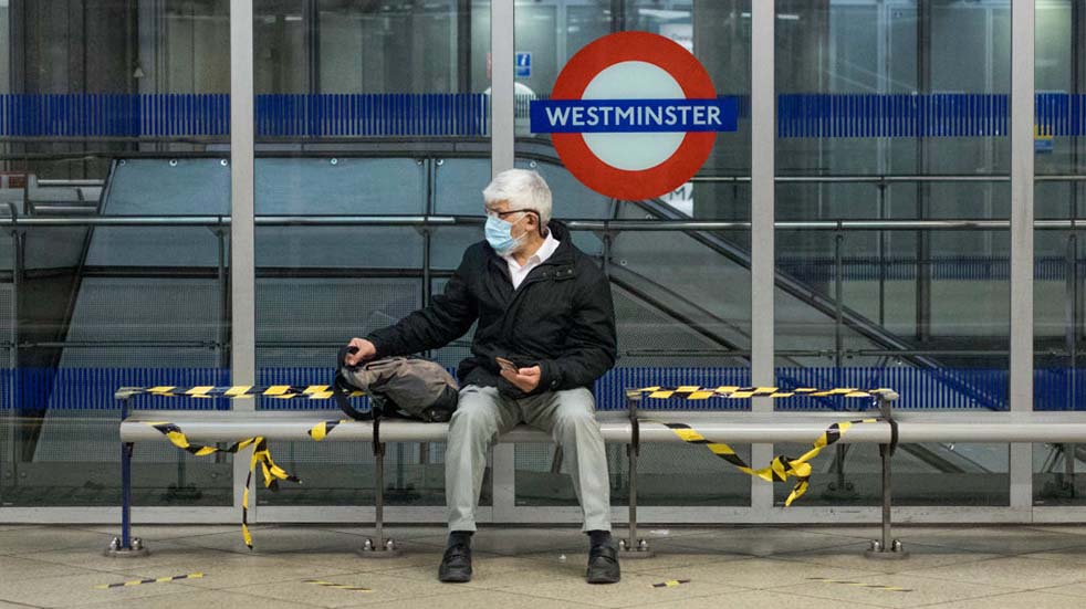 Public transport guidelines man sitting London Underground